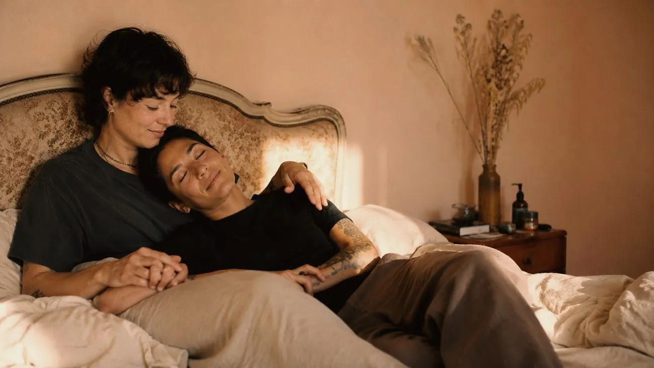 A couple resting close together in warm light